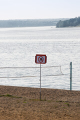 beach with a volleyball court and a swimming sign is not allowed