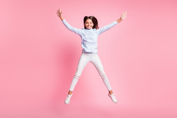 Fototapeta na wymiar Full length body size view of pretty cheerful girl jumping having fun like star isolated over pink pastel color background