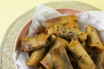 Pisang Aroma Cokelat or Banana chocolate spring roll, traditional Indonesian street food, made from banana fruit wrapped with spring roll stuff. Crispy texture and sweet taste. Isolated backround. 