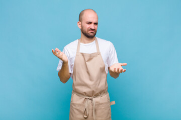 bald man looking puzzled, confused and stressed, wondering between different options, feeling...