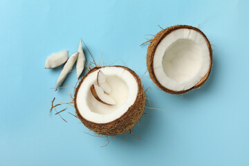 Fresh tasty coconut on blue background, top view