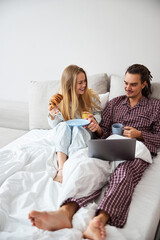 Happy couple in love having breakfast in bed