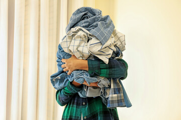 Woman hold bunch of crumpled laundry, space for text