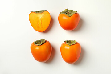 Flat lay with ripe persimmon on white background