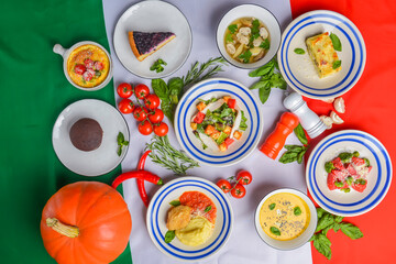 Italy food, dishes of Italian cuisine served over Italian flag. vegetable salad, soup. Seasonal autumn menu.