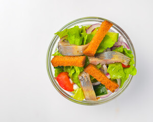 Serving of healthy vegetable salad with fish in a bowl. Delicious snack, healthy eating, isolated on white background.