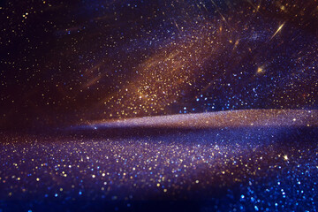 Obraz premium background of abstract glitter lights. Gold ,blue and black. de focused