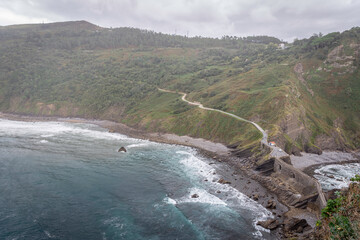 natural beach with cliff has a dramatic effect with the clouds