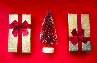 christmas tree and gifts on bright red background