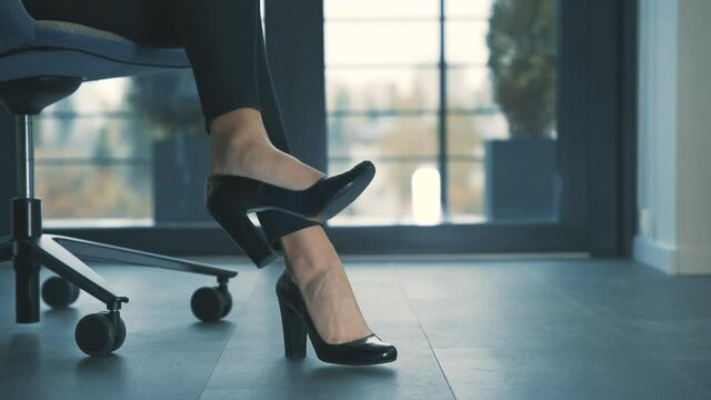 Business woman high heels in the office. Close-up.