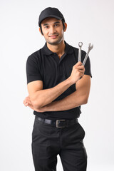 Mechanic in his uniform holding a spanner in his hand	