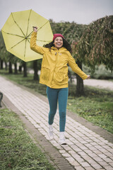 Obraz premium Cute with yellow umbrella looking joyful