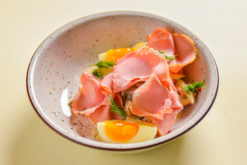 Boiled eggs with smoked ham and vegetables. Healthy vegetarian diet. Veggies salad.