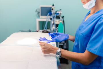 Doctor woman wearing surgical gloves in operation room