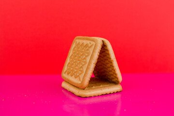 square cookies on a pink background on the table