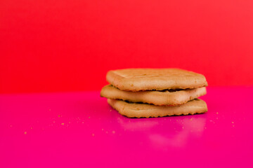 square cookies on a pink background on the table