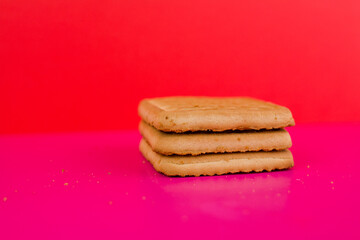 square cookies on a pink background on the table