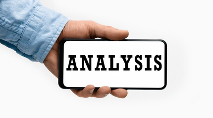 Closeup of a male hand holding Smartphone with word Analysis on display