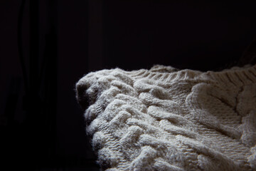 Texture of a knitted sweater over black background	