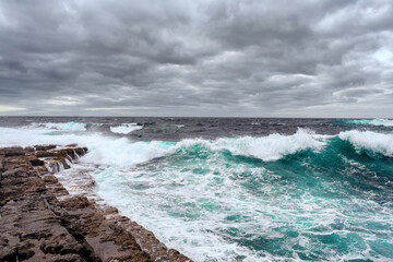 Beautiful waves of Atantic ocean and rough stone coastline. Landscape of Inishmore Aran islands, county Galway, Ireland.