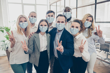 Photo of business people investors partners show v-sign wear formal clothes face mask healthcare...