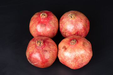 Fototapeta na wymiar large red pomegranate on black background