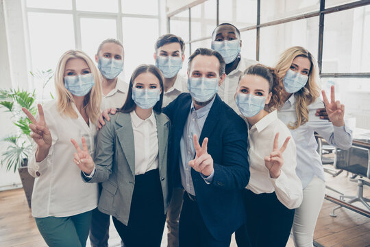 Photo of business people investors partners show v-sign wear formal clothes face mask healthcare indoors