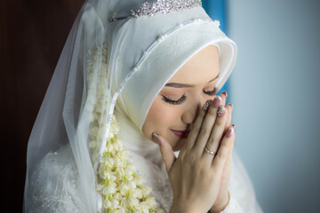 Makeup artist preparing bride before her wedding in room. Indonesian Wedding