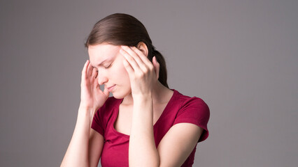 Young beautiful woman has headache