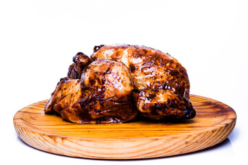 Tasty roast chicken on a wooden tray on white background