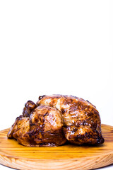 Tasty roast chicken on a wooden tray on white background