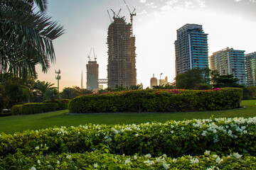 Shot from inside of a one of the most popular parks in Dubai. Zabeel park. UAE. Landmarks such Burj Khalifa, tallest building in the world and world trade center building can bee sen on the scene © Four_Lakes
