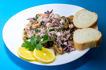 Seafood on white plaite. Top view, blue background