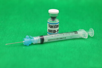 Covid19 SARS-Cov-2  syringe and vials vaccines with English text and Green Chroma background