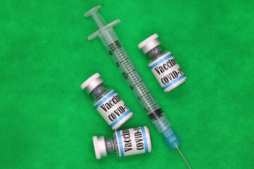 Covid19 SARS-Cov-2  syringe and vials vaccines with English text and Green Chroma background