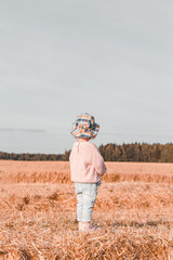 Little girl s in a wheat field. Back to nature. Reconnecting with nature. Vertical format
