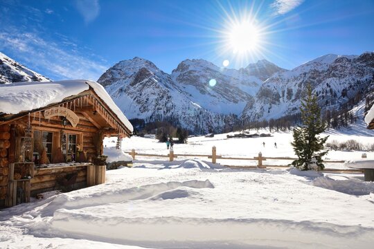 A house covered in snow with stunning view into the snow covered mountains at Sertig Davos Switzerland