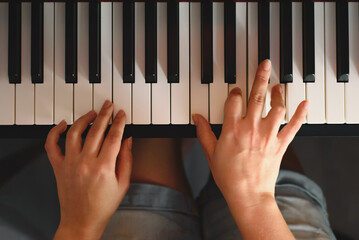 A woman plays the piano at home. Hobbies and homeschooling