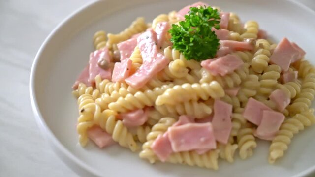spirali or spiral pasta mushroom cream sauce with ham - Italian food style