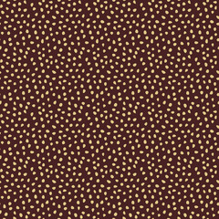 Seamless background with random golden elements. Abstract ornament. Dotted abstract pattern