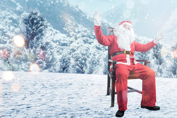 Asian man in Santa costume sitting on a wooden chair with snowfall background