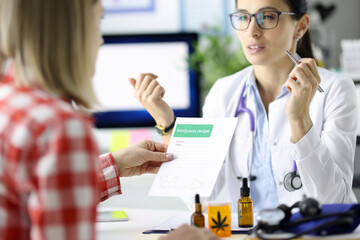 Doctor giving patient prescription for drug in clinic