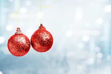 Red Christmas ball hanging with blurred light background