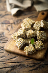 Healthy seeds honey squares on a wooden desk