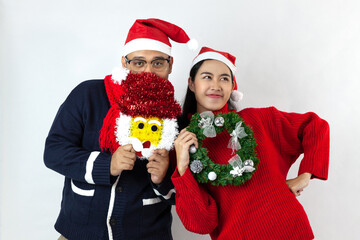 asia couple smile together wearing santa hat on white background