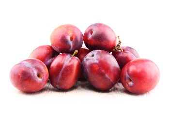 Composition with plums isolated on white background