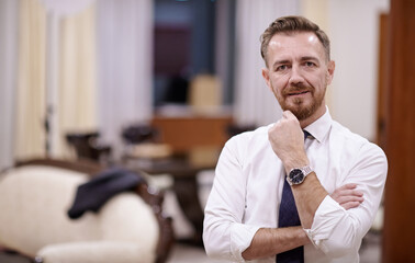 Portrait of smiling ceo at modern office in stylish suit