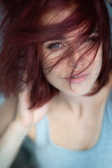 Beautiful young stylish ginger woman wearing casual clothes posing at home.