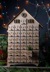 Wooden advent calendar for waiting new year or christmas. Box with cells from 1 to 25 and 31 for...