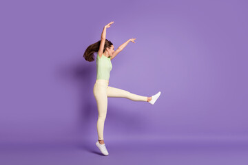 Full length body size profile side view of nice attractive cheerful cheery funky sporty girl jumping dancing professional move isolated bright vivid shine vibrant lilac violet color background